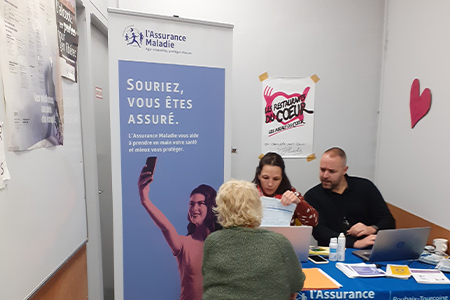 photo d'un stand de la CPAM de Roubaix-Tourcoing avec les Resto du Coeur.